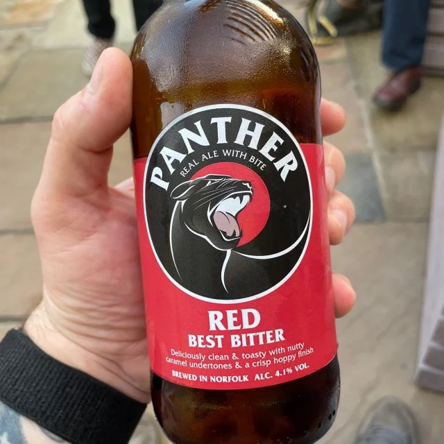 Panther red bottle in customers hand